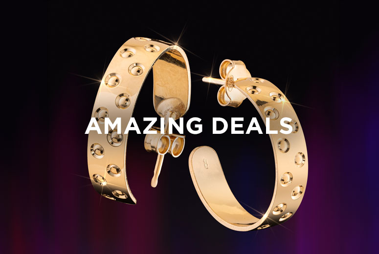 Gold earrings on black background